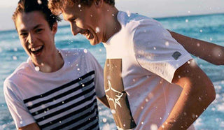 Image of two men running at the beach, wearing Paul & Shark t-shirts