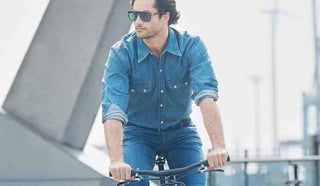 Image of man riding a commuter bike in the city wearing Alberto pants