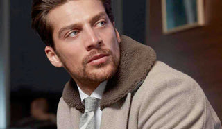 Side profile picture of man wearing a coat from Eleventy