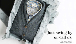 Picture of greay cardigan inside of a gift box