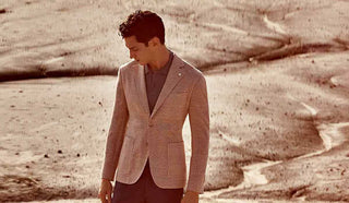 Picture of man in an empty field, wearing a sport coat from LBM1911