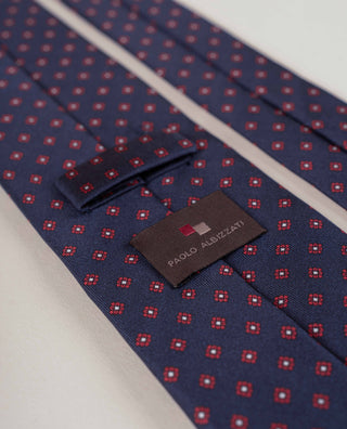 A navy micro-flower silk tie by Paolo Albizzati, showing its label